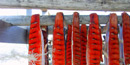 Image of salmon cut for drying hang on a wooden rack, exposing the pink-red meat. Image of salmon cut for drying hang on a wooden rack, exposing the pink-red meat.