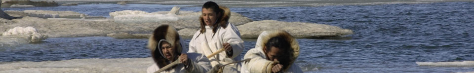 Three Iñupiat men paddling a whaling boat