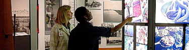 Two visitors look at an exhibit at the Acadian Cultural Center.