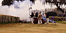 Men dressed as 1815 soldiers fire cannon. Men dressed as 1815 soldiers fire cannon.