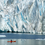 Kayaker by a tidewater glacier