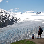 Hikers overlook Exit Glacier at the Top of the Cliffs along the Harding Icefield Trail