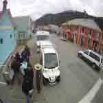Ranger stands in front of electric vehicles and talks to park visitors