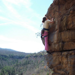 Woman climbing cliff at Obed.  Photo by Ranger Matt Hudson.