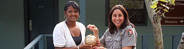 Park Superintendent Barbara Goodman (right) with artist Suzanne Pickett (right) and the ornament she painted for the White House tree