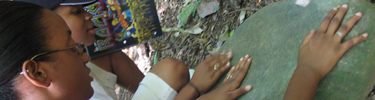 Two teenaged girls examine a matata along the Reef Bay Trail.