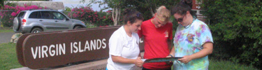 Visitors, with their vehicle in background, review map of the Park