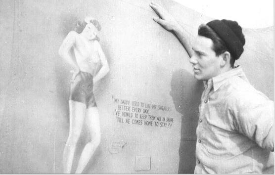George Sproul (ARM) observes the fuselage nose art on one of the squadrons planes