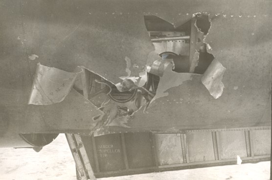 Large hole in the bottom of a B-26 bomber