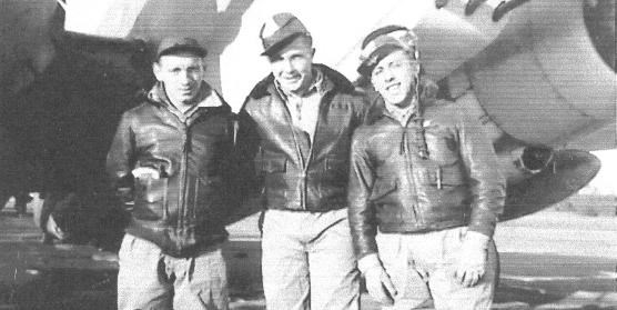 Three men in front of a plane