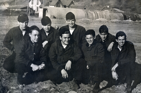 Crew members of the USS Albuquerque sit in an Unalaska village