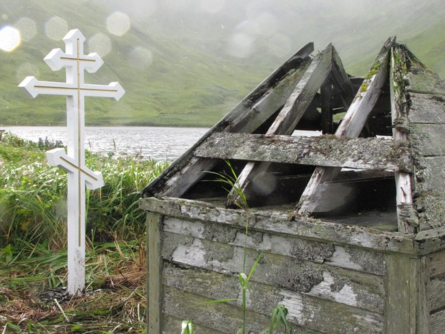 Small structure and Russian cross in rainy landscape