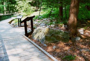 view of boardwalk and display between visitor center and historic area