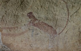 A roughly painted, red panther rearing up on its hind legs with a very long tail arching over its back.