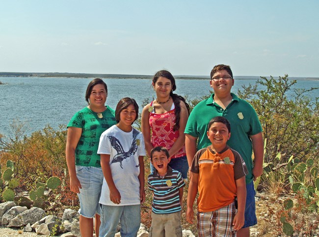 Group of 5 Jr Rangers of various ages in front of lake at Amistad