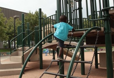 A child climbs on play equipment.
