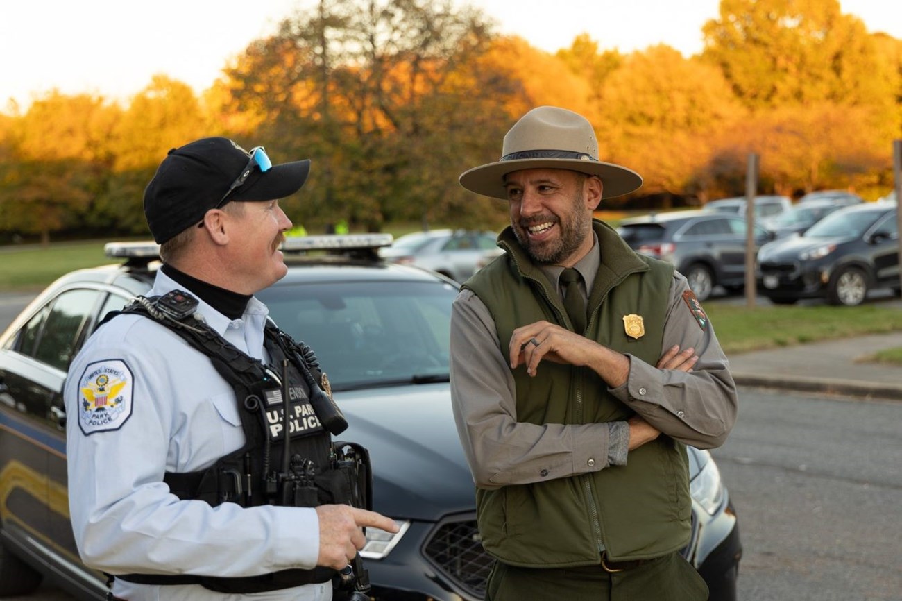 A Park Ranger smiles with a Park Police Officer