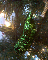 Glass pickle ornament among decorations on a Christmas Tree