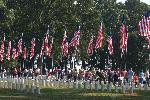 Volunteers gather to begin placing flags on graves