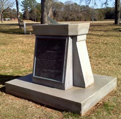 Stone monument with bronze sundial and plaque