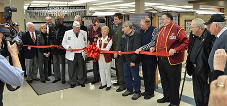 A group of people cut a ribbon