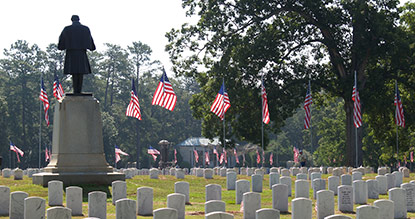 Cemetery decorated with flags for Memorial Day