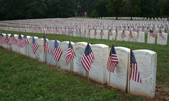 American flags in front of graves in the National Cemetery