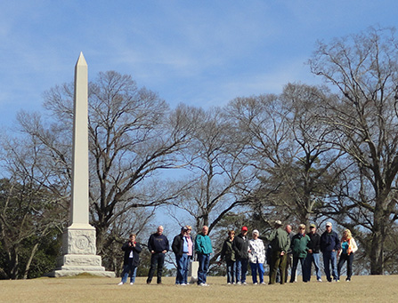 Visitors listen to a volunteer leading a tour.