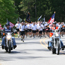 Runners and motorcycles on a park road