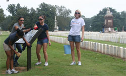 Volunteers clean an exhibit panel