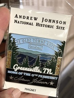A magnet with mountains and trees behind Greeneville's "old town gate," an archway that spans Tusculum Boulevard