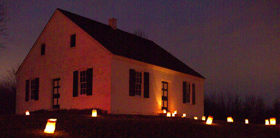 The Dunker Church glows from the lights of the luminaries