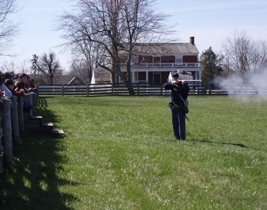 Ranger Bert Dunkerly demonstrates firing a gun for students.