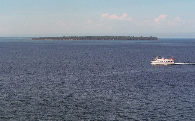 A passenger cruise boat travelling across the waters of Lake Superior on a sunny day