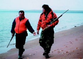 Hunters hiking the beach