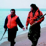Hunters hiking the beach