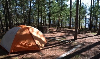 Orange tent on tent pad at campsite eight on Stockton Island, overlooking Lake Superior.
