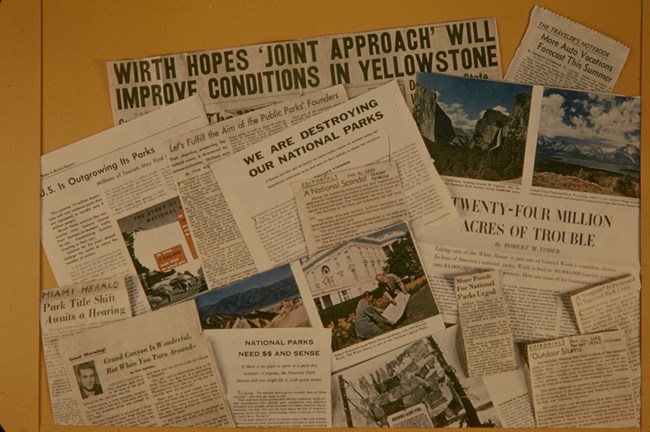 An array of newspaper clippings showing many headlines about the declining state of the parks
