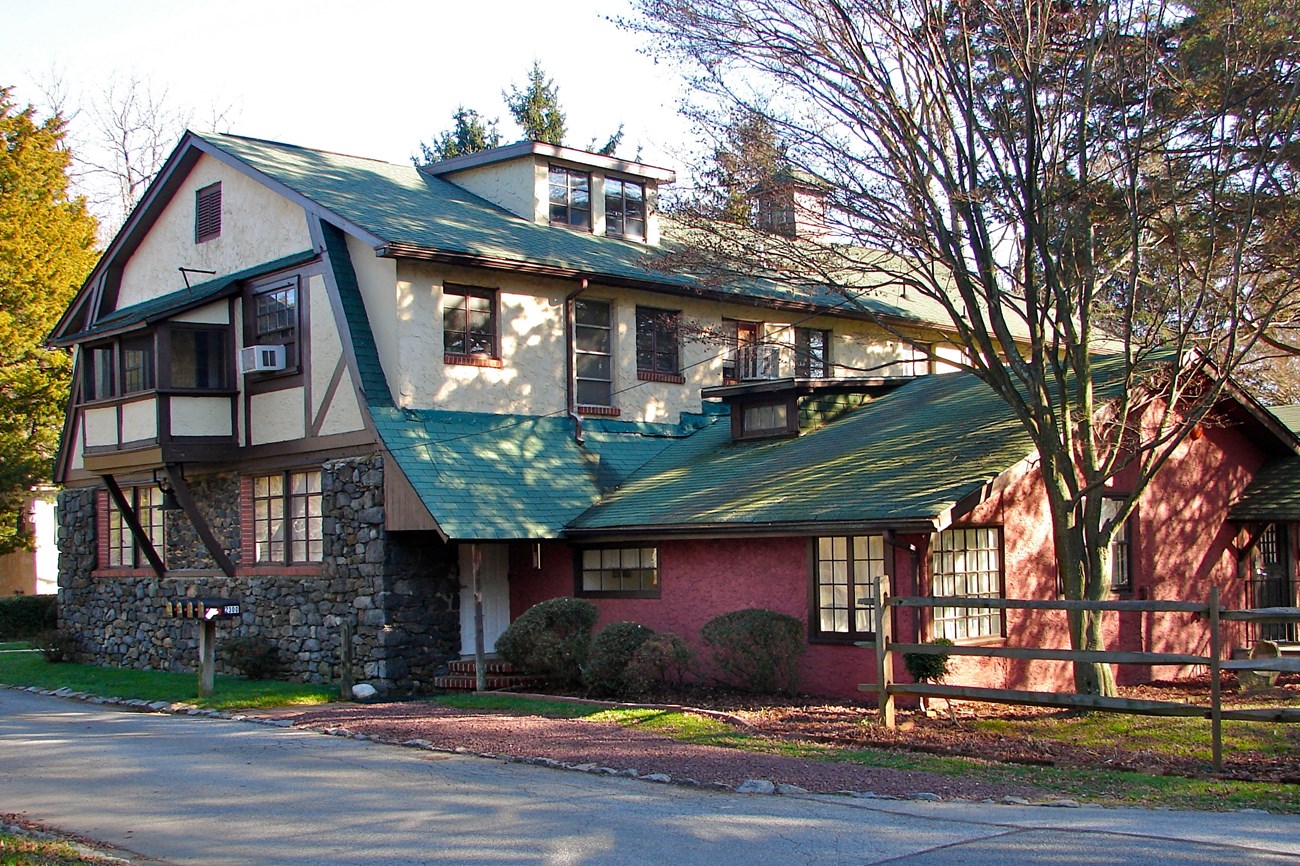 Photograph of Arden Craft Shop two story Germanic style building, stone first floor, tan second floor and a green roof with a red one story extension to the right