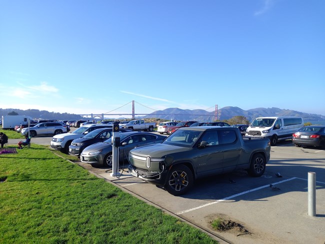 An Electric Vehicle charger at Crissy Field with the Golden Gate Bridge in background
