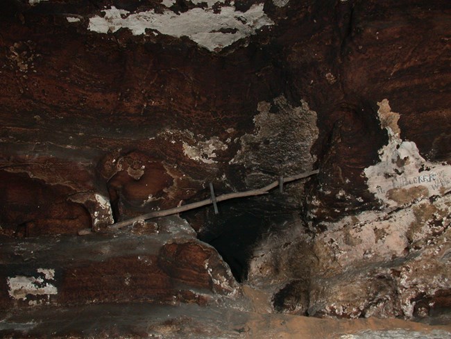 a wooden pole with two ladder like steps.