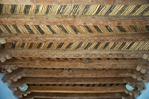 Colorful cottonwood vigas (ceiling beams), corbels and willow saplings salvaged from Socorro’s fallen 18th-century mission boast the red, black and yellow geometric designs of the Piro artisans who painted them. Photo © Jack Parsons