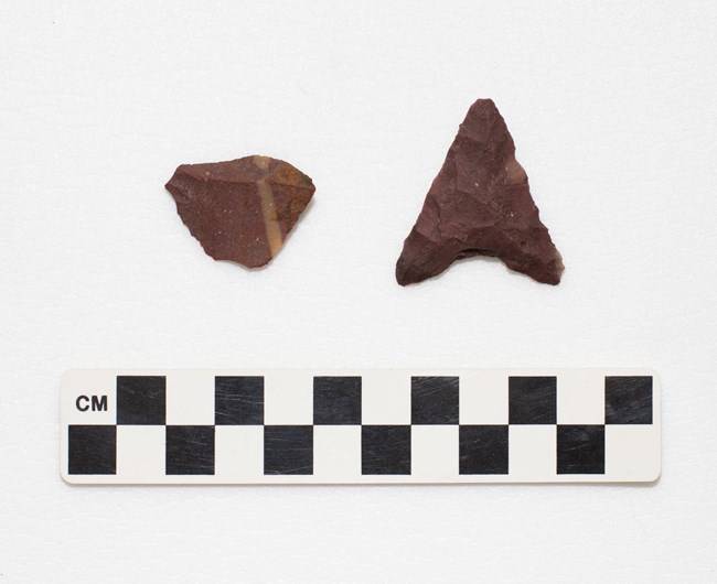 A triangular shaped projectile point with concave shaped base.