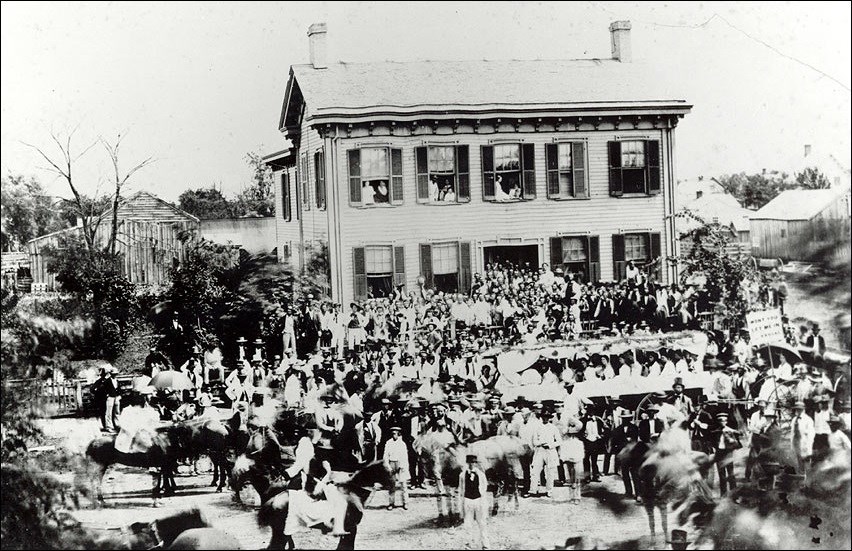 Photo of a large house surrounded by people. (Courtesy Abraham Lincoln Presidential Library)