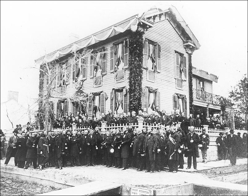 Two story home with a crowd of people in front dressed in black. (Courtesy Abraham Lincoln Presidential Library & Museum)