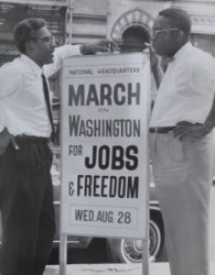 two black men next to a sign that reads march on washington for jobs and freedom
