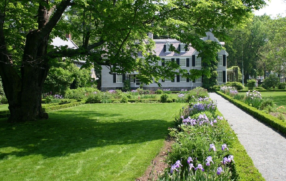 Garden leading to a three-story white house