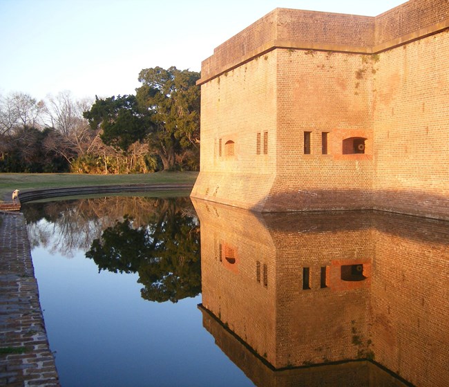 exterior masonry wall and water-filled moat