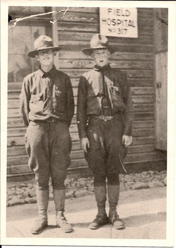 Black and white photo shows two young men in uniform outside field hospital at Camp Lee, Virginia