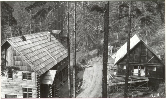 Black and white image of wooden buildings belonging to the Ohanapecosh Hot Springs Resort.